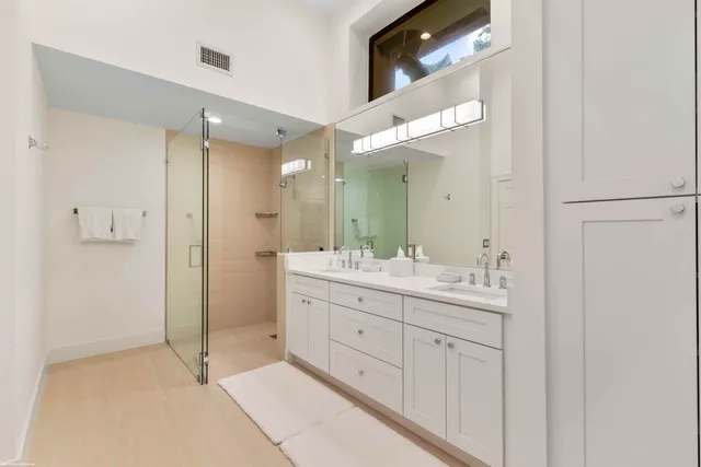 a bathroom with a double vanity sink and a mirror
