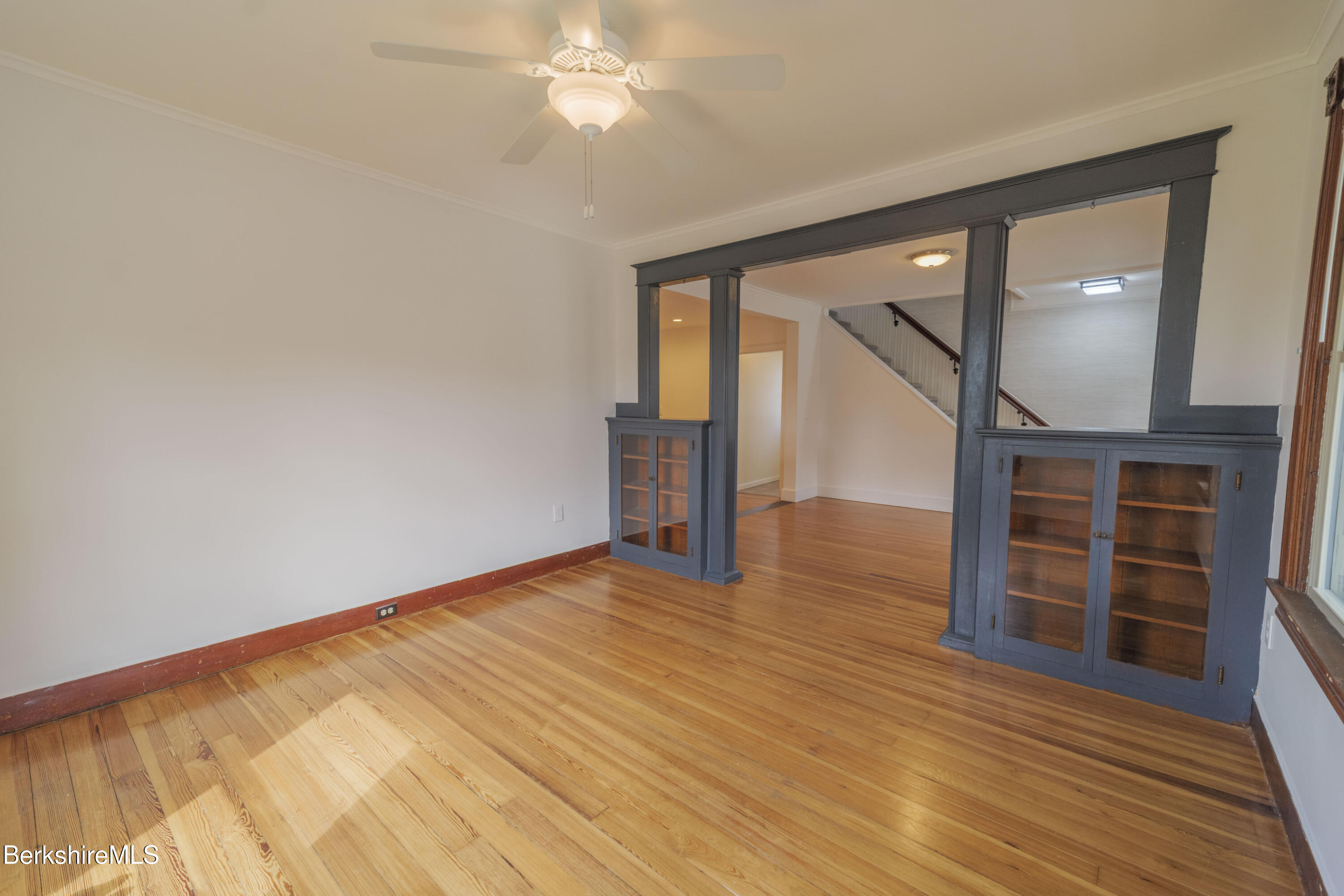 108 North Summer Street Adams, MA 01220 - Photo 3 of 28 a view of empty room with wooden floor and fan