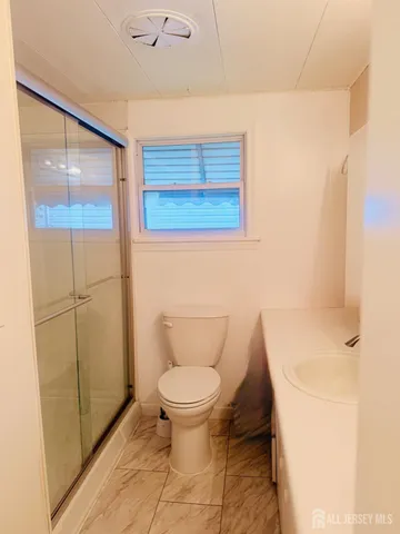 a white toilet sitting next to a bathroom sink