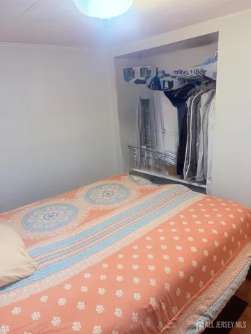 a bedroom with a bed and a mirror