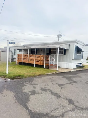 a view of a house with a backyard and porch