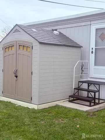 a view of a backyard with plants and brick wall