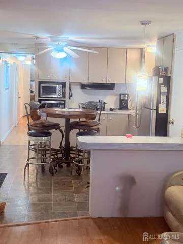 a kitchen with kitchen island a counter top space a sink stainless steel appliances and cabinets