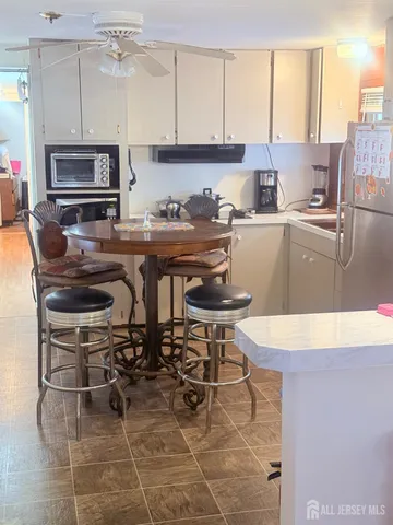 a kitchen with stainless steel appliances kitchen island granite countertop a sink and cabinets