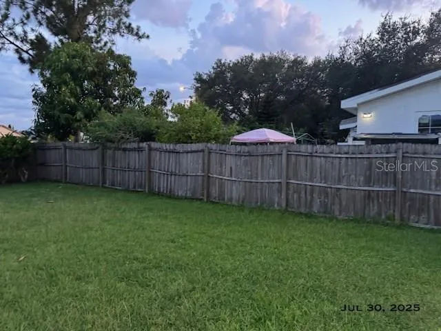 a house view with a big yard