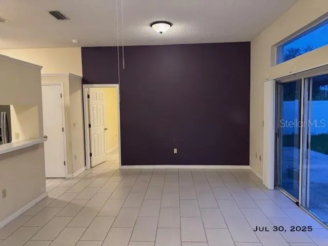 an empty room with closet and wooden door