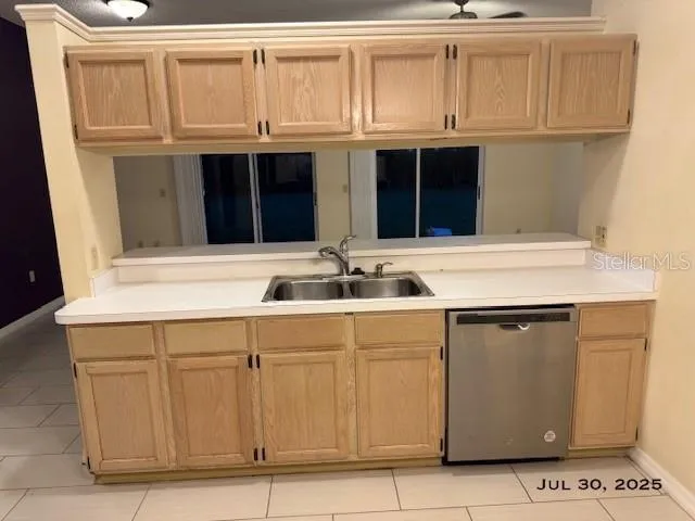 a kitchen with granite countertop white cabinets and sink