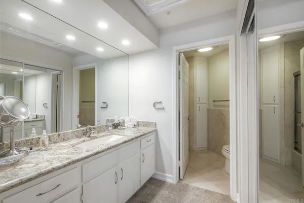 a bathroom with a granite countertop sink mirror and double
