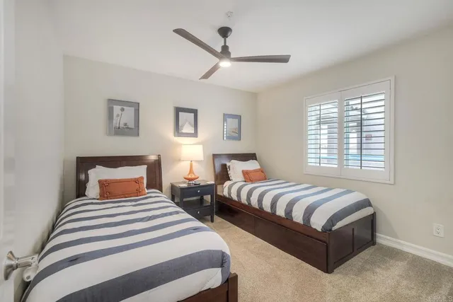 a bedroom with two beds and ceiling windows