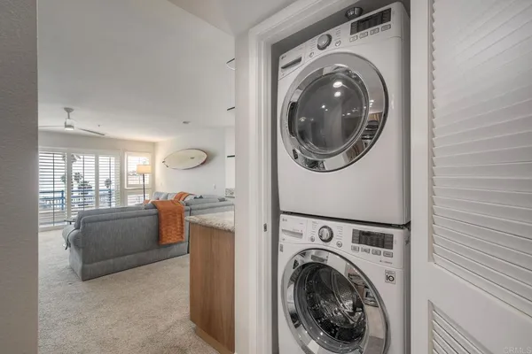 a view of a storage and utility room with washer and dryer