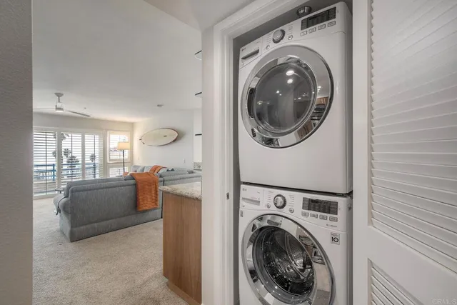 a view of a storage and utility room with washer and dryer