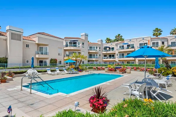 a view of a swimming pool with outdoor seating