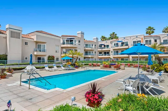 a view of a swimming pool with outdoor seating