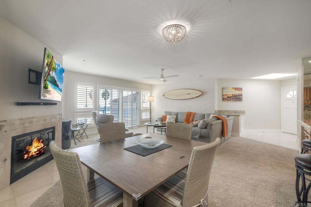 400 North Pacific Street, Unit 314 Oceanside, CA 92054 - Photo 4 of 20 a view of a dining room with furniture a fireplace and wooden floor