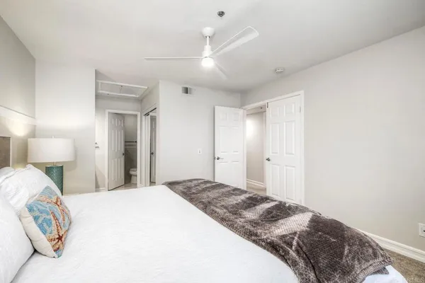 a bedroom with a bed and a lamp