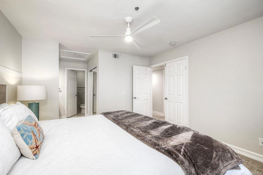 400 North Pacific Street, Unit 314 Oceanside, CA 92054 - Photo 10 of 20 a bedroom with a bed and a lamp