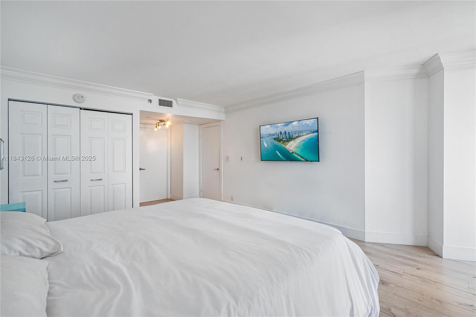 2000 Towerside Terrace, Unit PH9 Miami, FL 33138 - Photo 14 of 40 a bedroom with a bed and a window