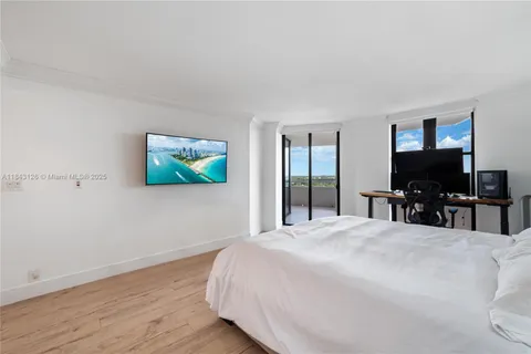 a view of a livingroom with furniture hardwood floor and workspace