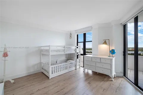 a bedroom with furniture and baby crib