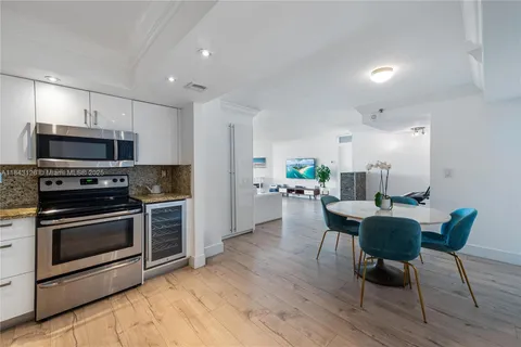 a kitchen with microwave a stove and chairs