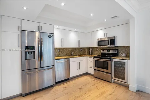 a kitchen with stainless steel appliances and refrigerator