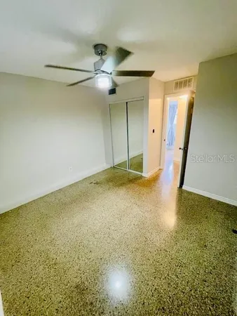 a view of walk in closet with empty racks