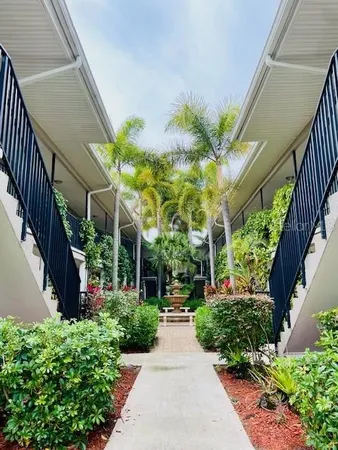 a view of a pathway of a house with a garden