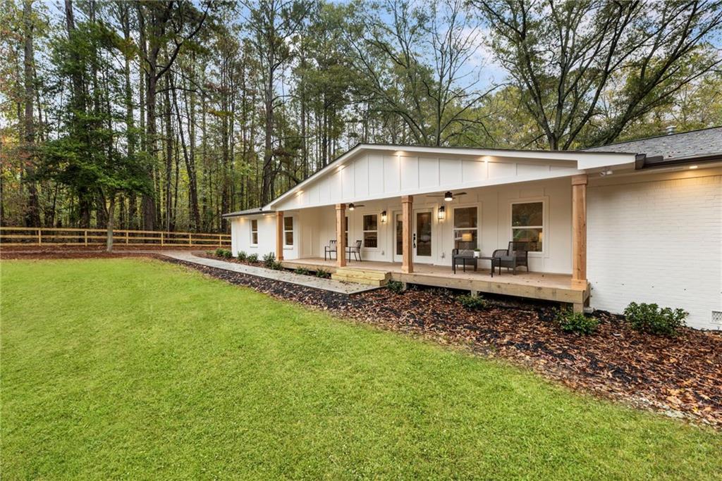a view of a house with a yard and sitting area