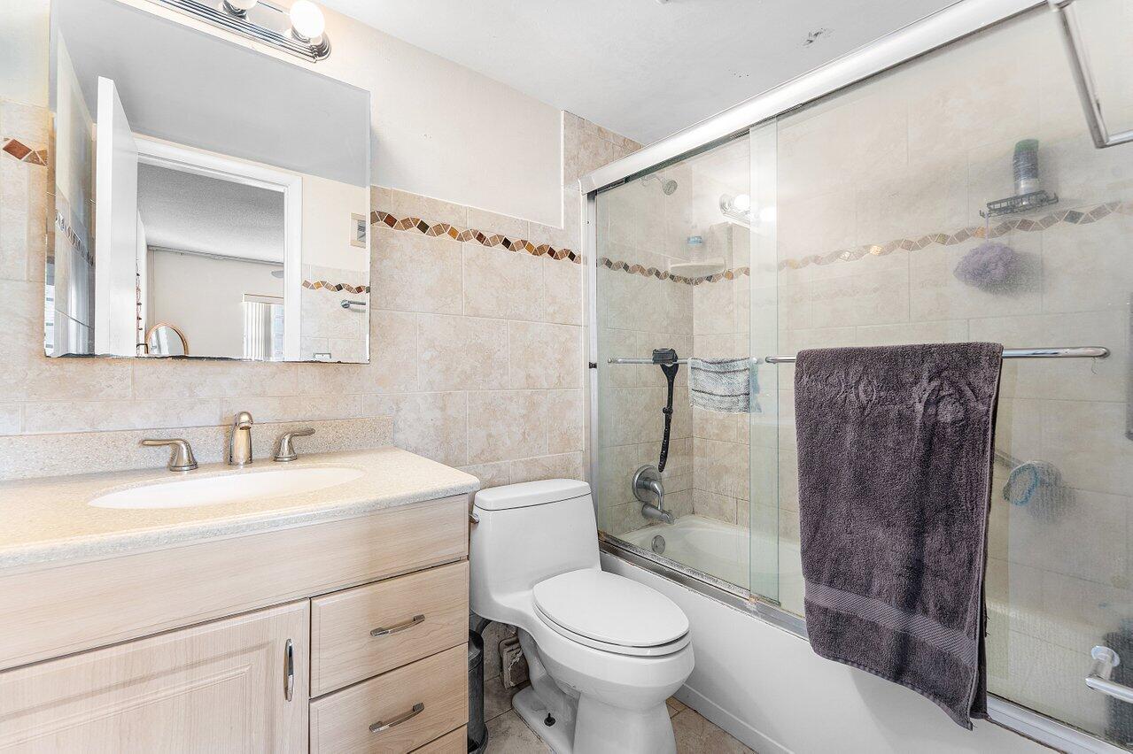 5701 Northwest 2nd Avenue Boca Raton, FL 33487 - Photo 15 of 26 a bathroom with a sink toilet and shower