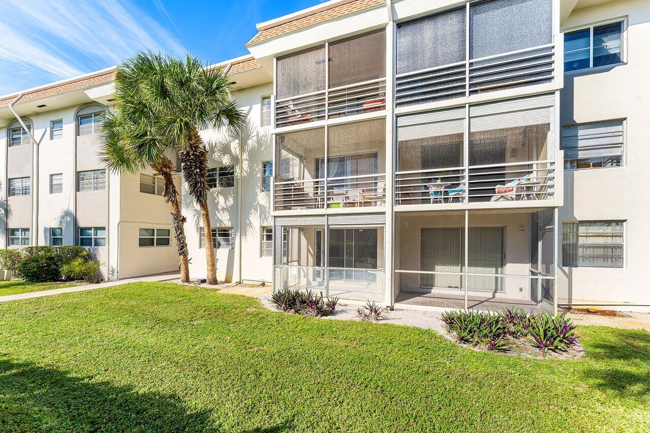 5701 Northwest 2nd Avenue Boca Raton, FL 33487 - Photo 22 of 26 a front view of a house with a yard