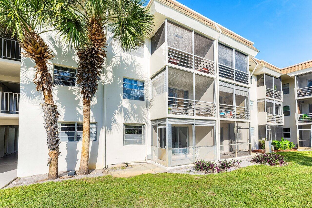 5701 Northwest 2nd Avenue Boca Raton, FL 33487 - Photo 23 of 26 a front view of a house with a yard and plants