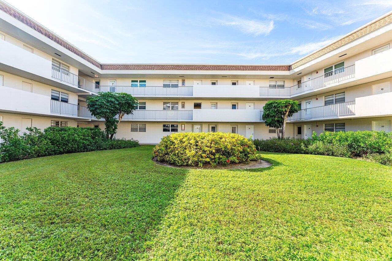5701 Northwest 2nd Avenue Boca Raton, FL 33487 - Photo 24 of 26 a view of a big house with a big yard and potted plants