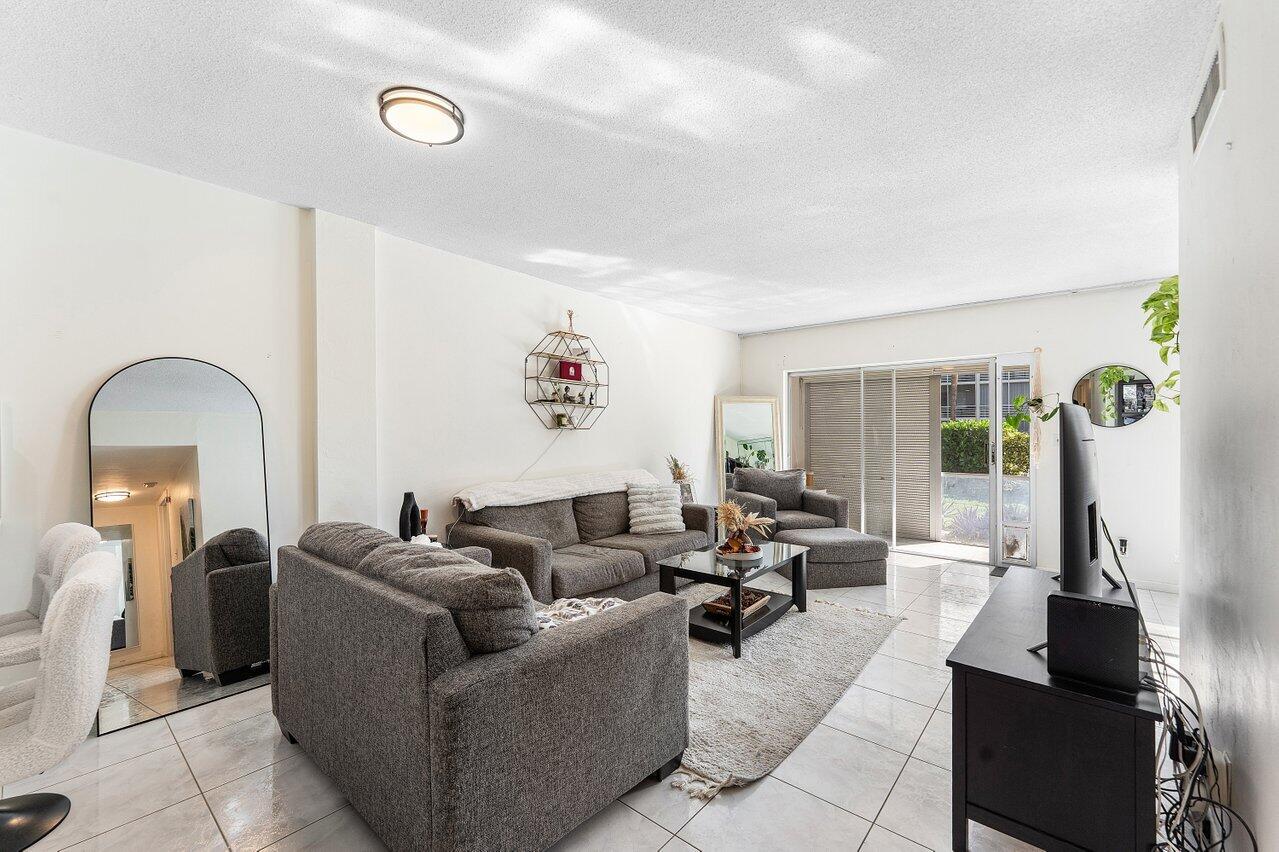 5701 Northwest 2nd Avenue Boca Raton, FL 33487 - Photo 8 of 26 a living room with furniture and a large window