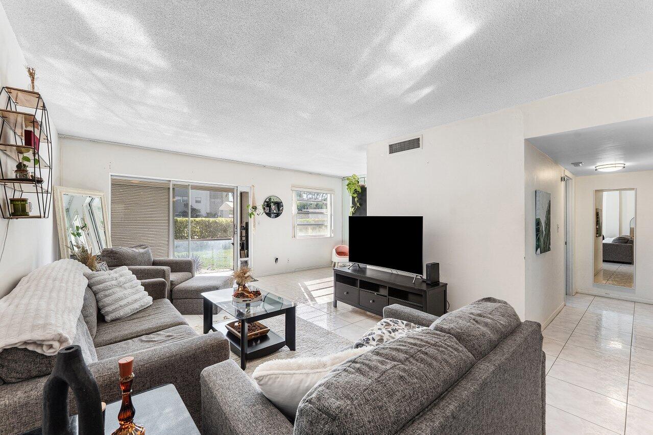 5701 Northwest 2nd Avenue Boca Raton, FL 33487 - Photo 9 of 26 a living room with furniture and a flat screen tv