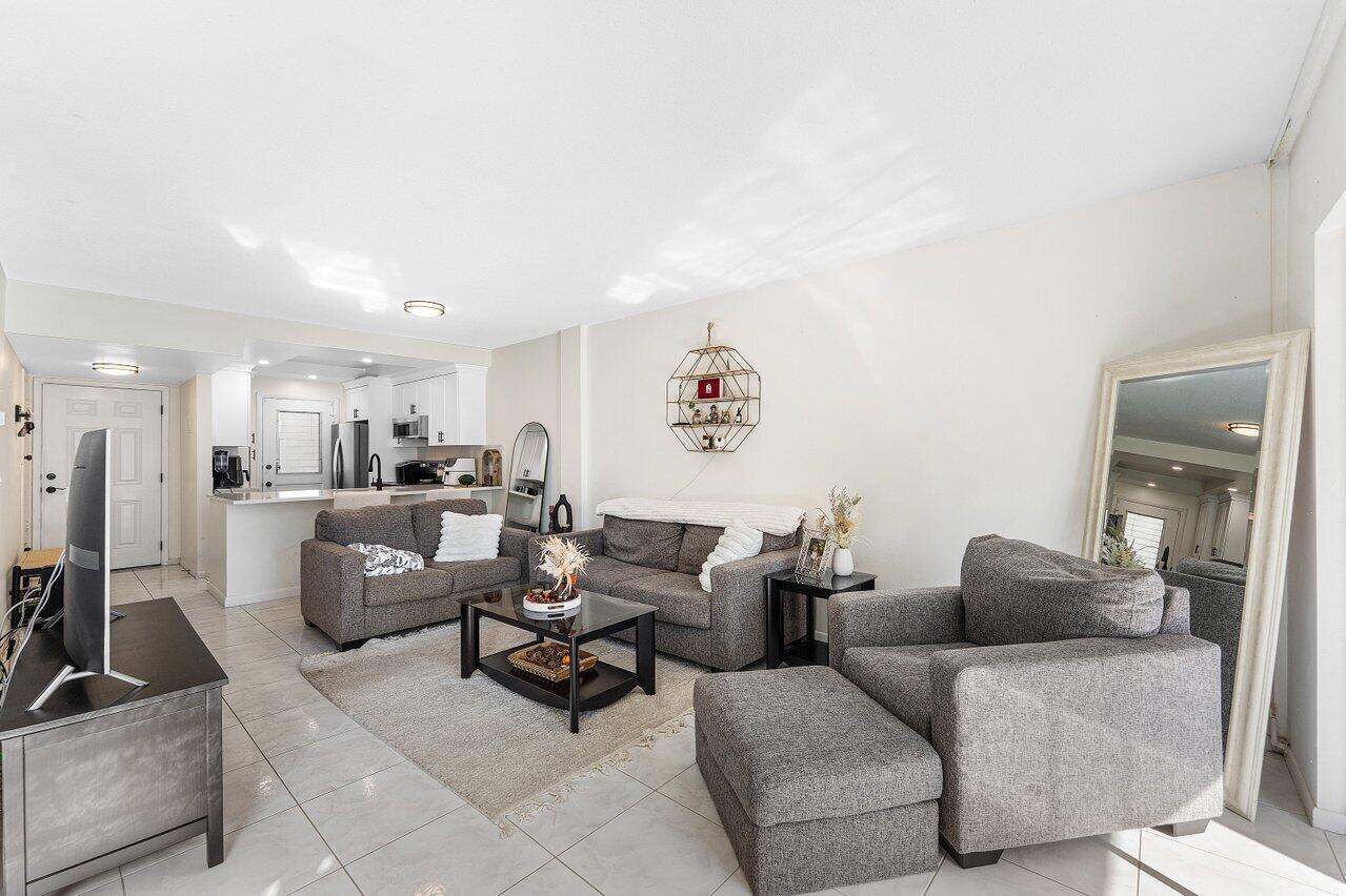 5701 Northwest 2nd Avenue Boca Raton, FL 33487 - Photo 10 of 26 a living room with furniture and a view of kitchen
