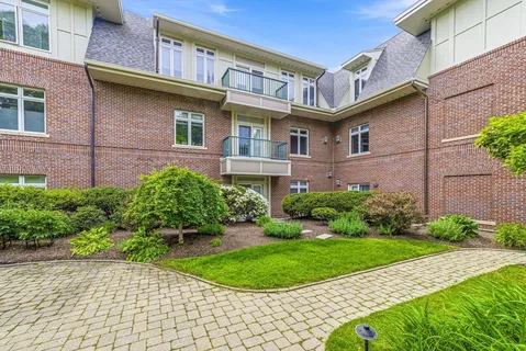 a view of a brick building with a yard