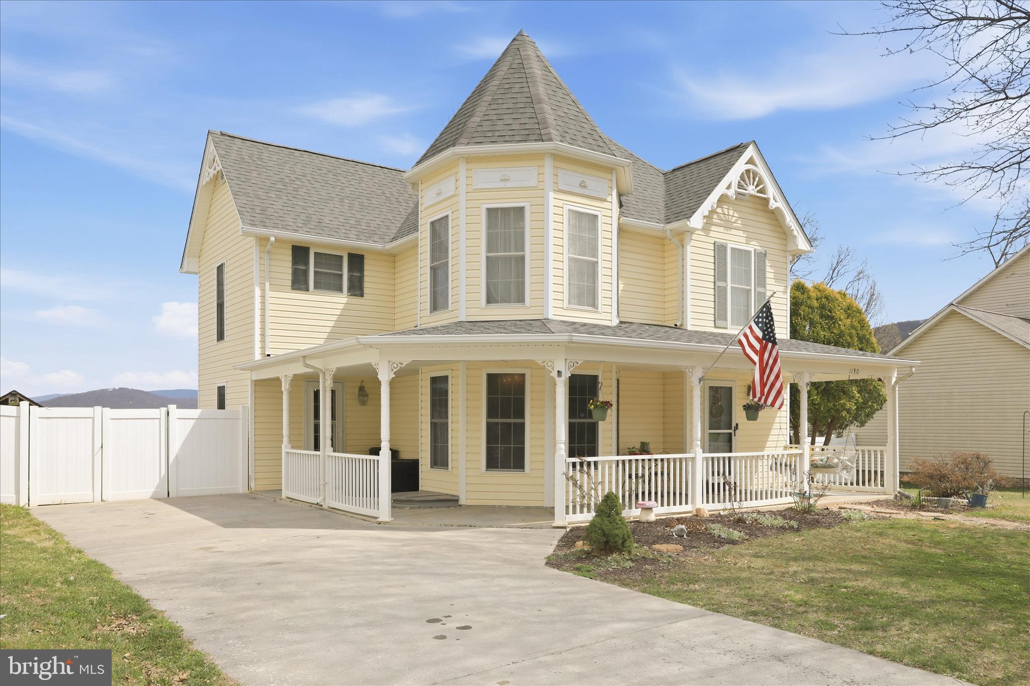 1130 Happy Ridge Drive Front Royal, VA 22630 - Photo 2 of 42 a view of a brick house with large windows next to a yard
