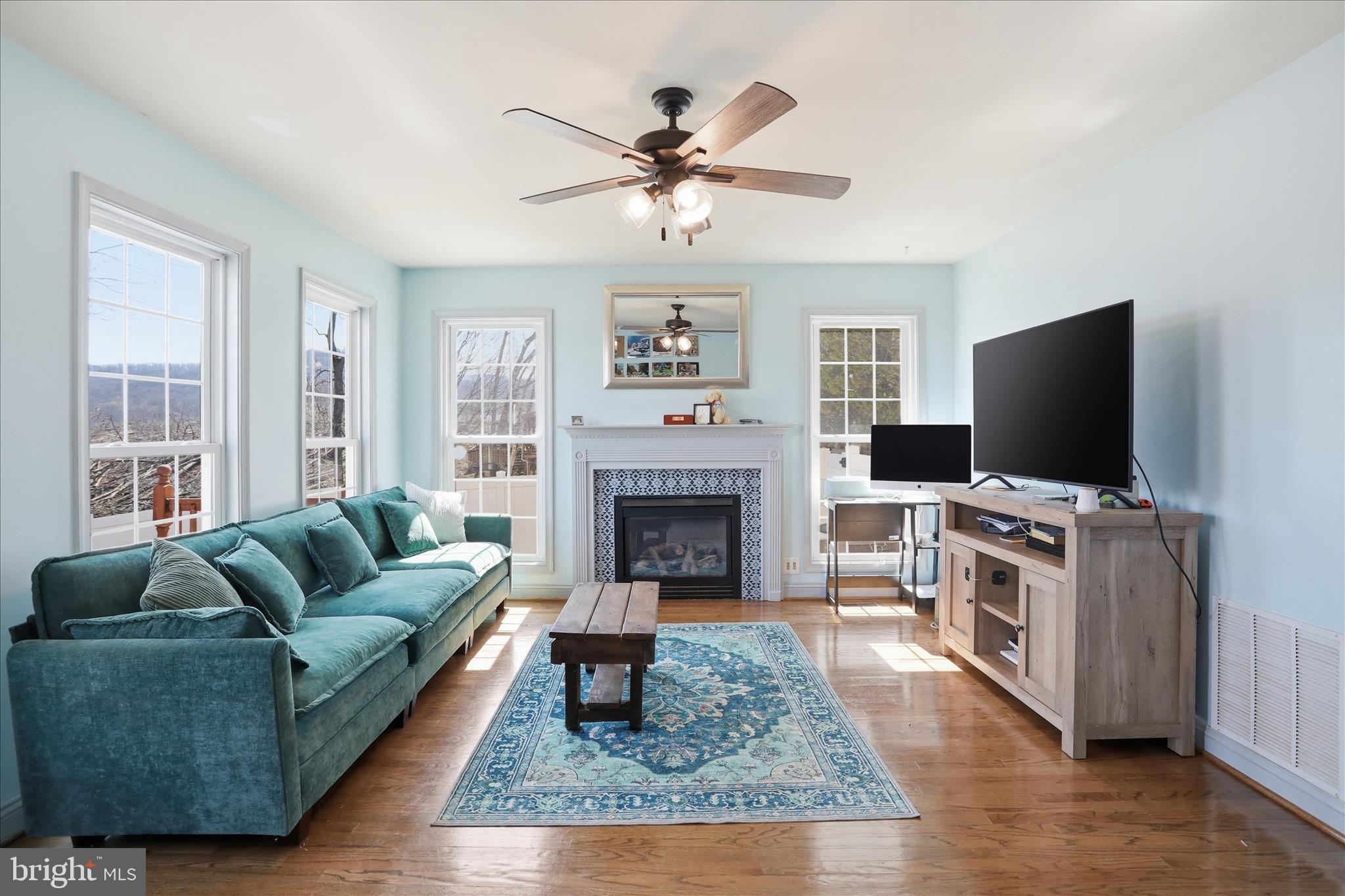 1130 Happy Ridge Drive Front Royal, VA 22630 - Photo 8 of 42 a living room with furniture a flat screen tv and a fireplace
