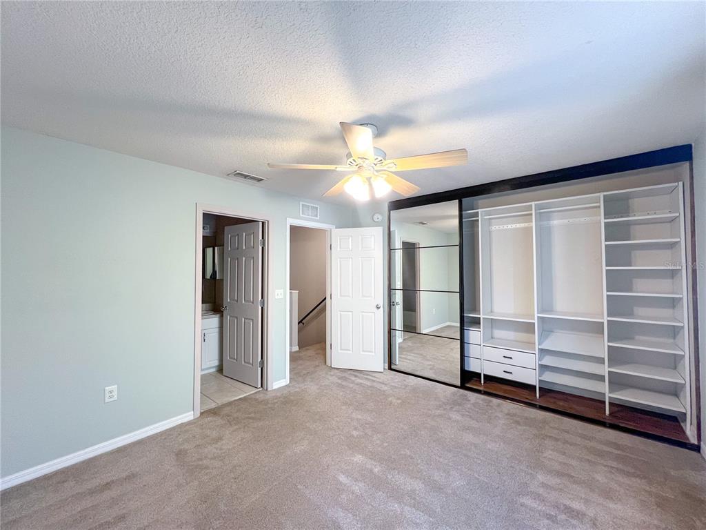 2306 Southwest 42nd Drive, Unit 144 Gainesville, FL 32607 - Photo 7 of 11 an empty room with a ceiling fan closet and window