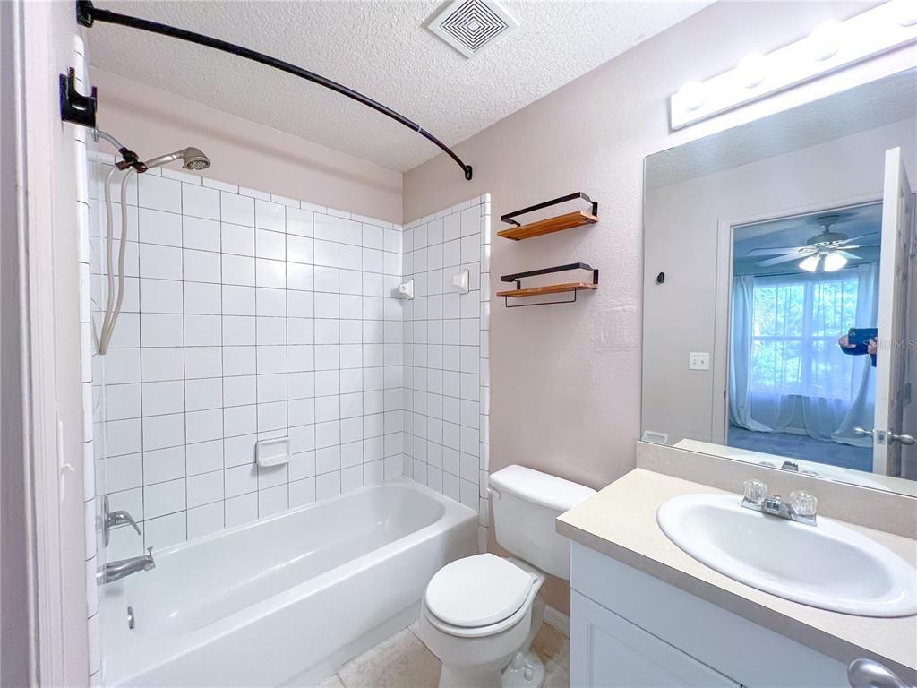 2306 Southwest 42nd Drive, Unit 144 Gainesville, FL 32607 - Photo 8 of 11 a bathroom with a sink mirror toilet and bathtub