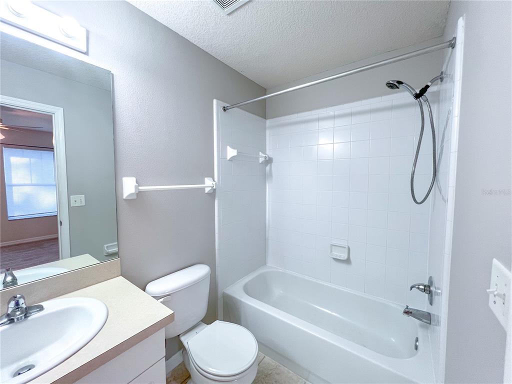 2306 Southwest 42nd Drive, Unit 144 Gainesville, FL 32607 - Photo 10 of 11 a bathroom with a bathtub shower sink vanity and toilet