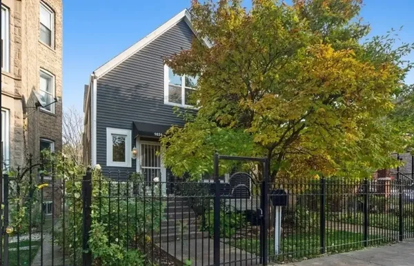 a view of a house with a small yard and plants