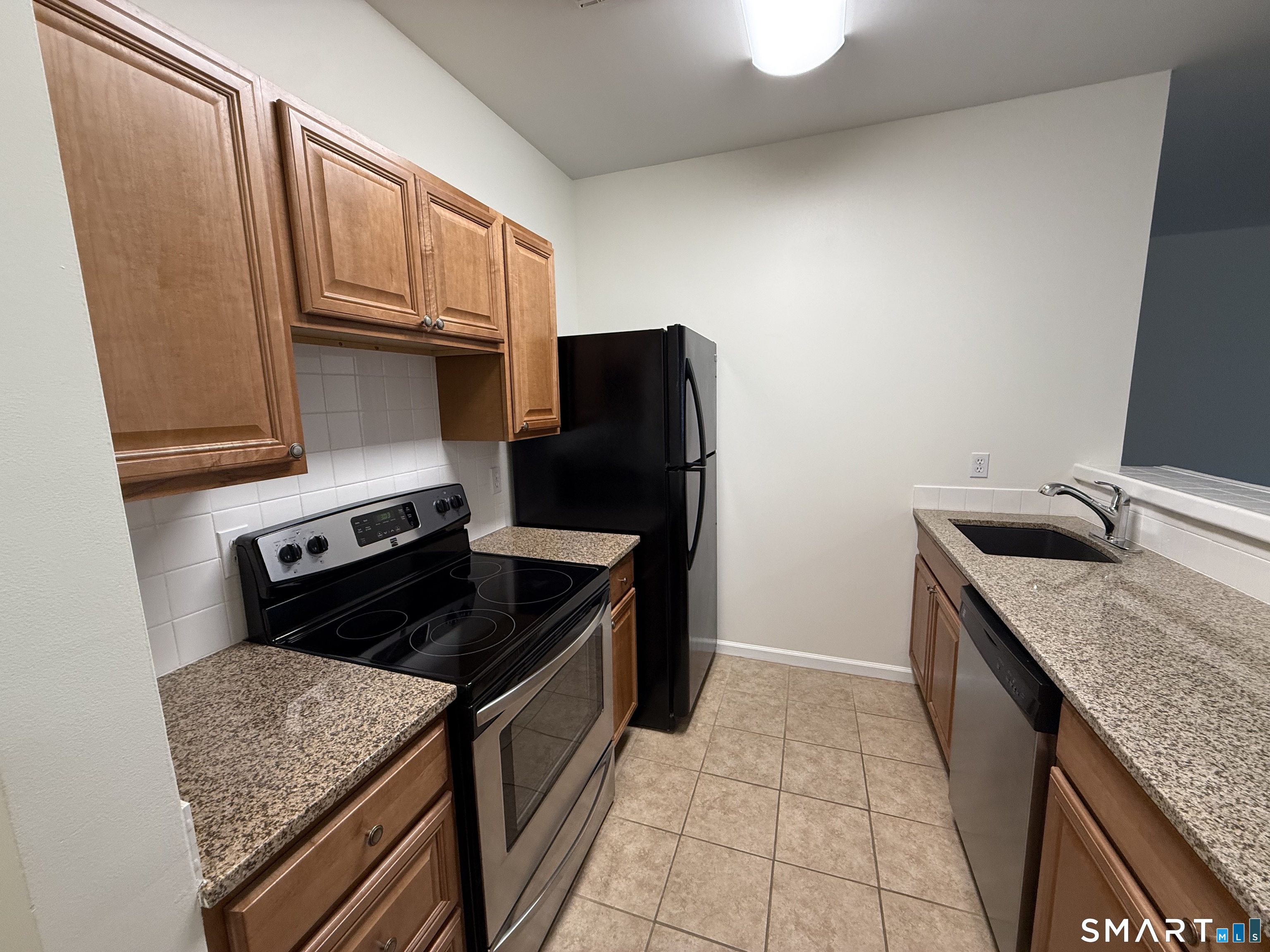 84 Wall Street Norwalk, CT 06850 - Photo 3 of 12 a kitchen with granite countertop a stove sink and cabinets