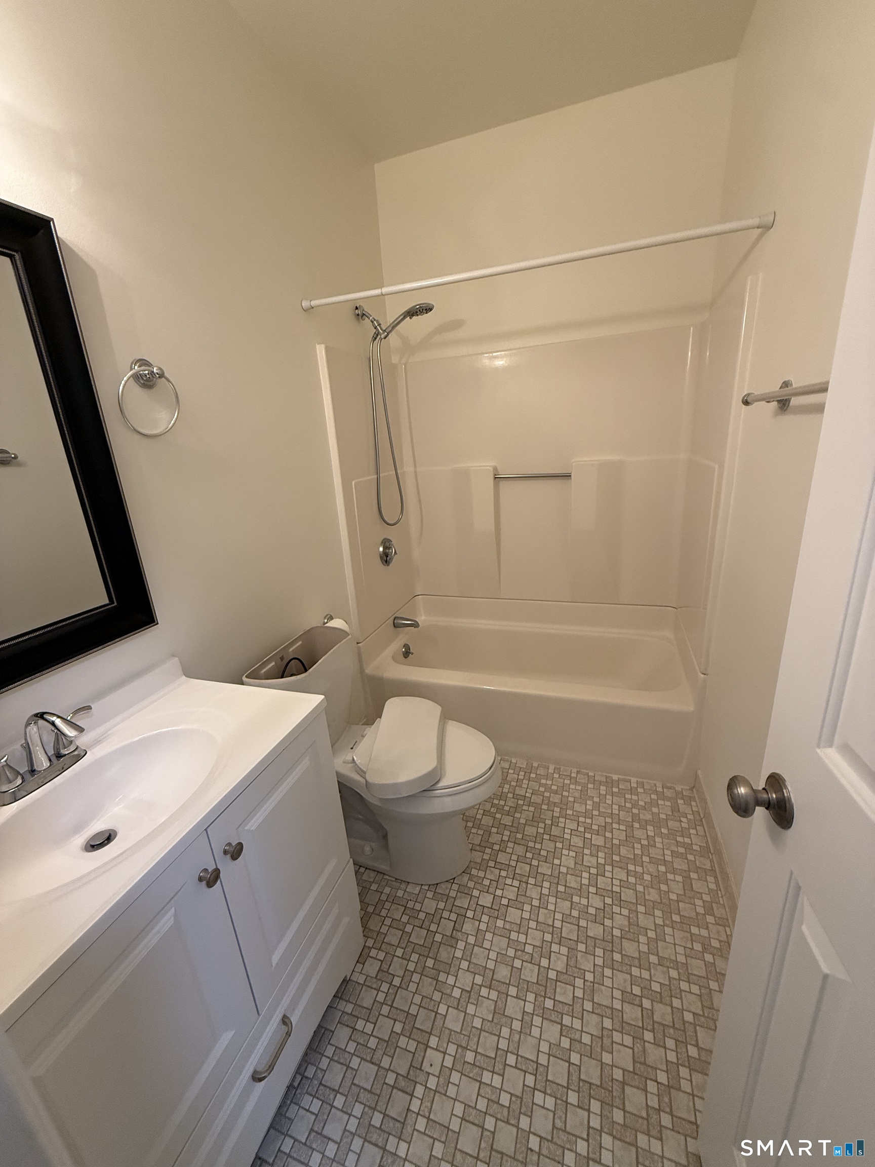 84 Wall Street Norwalk, CT 06850 - Photo 5 of 12 a bathroom with a granite countertop sink toilet a mirror and shower