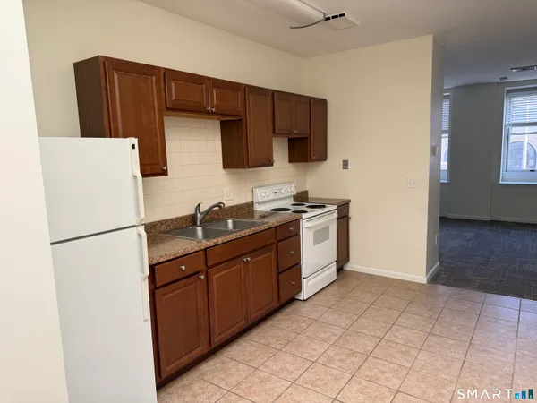 a kitchen with stainless steel appliances a refrigerator sink and microwave