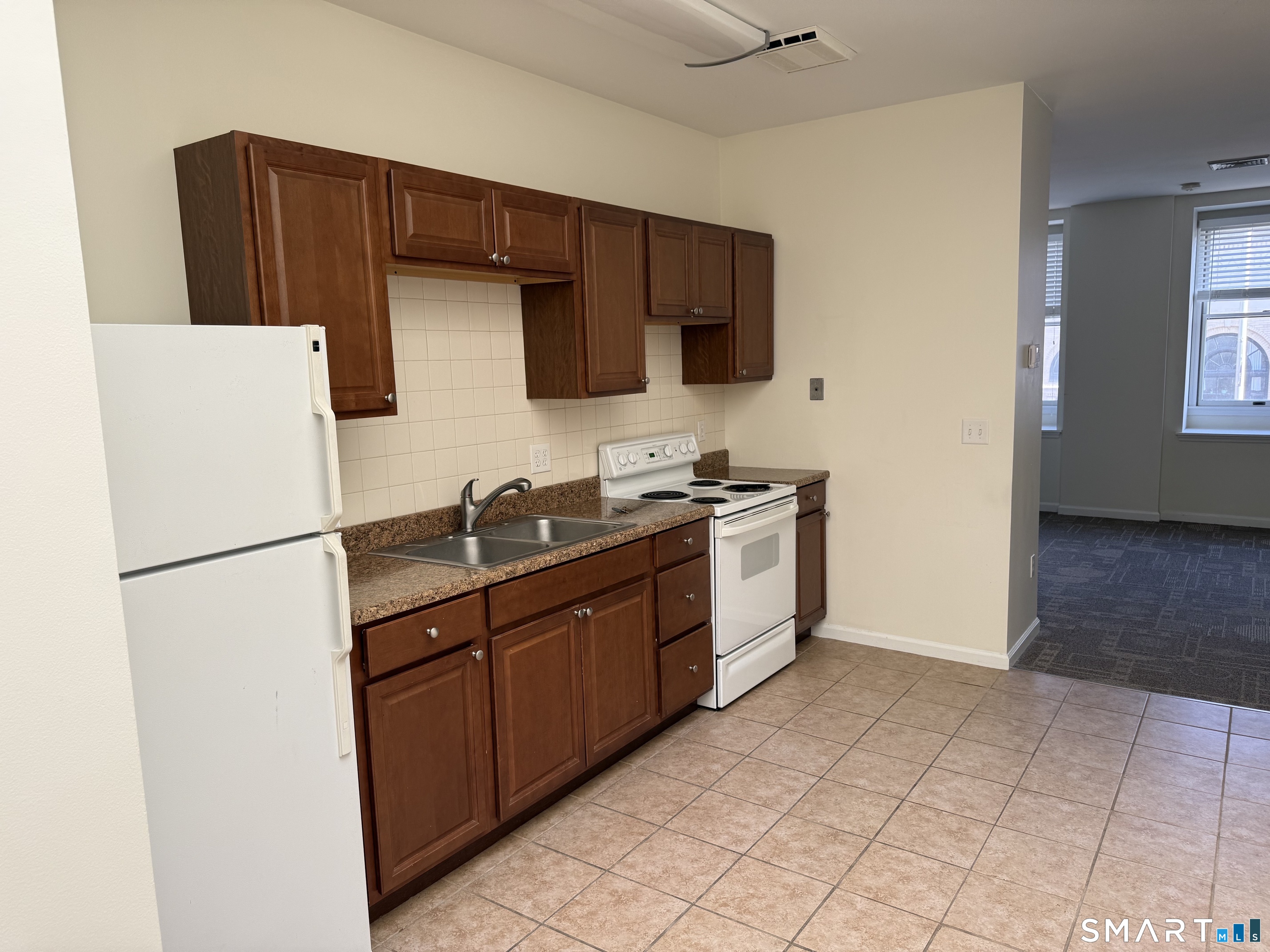 84 Wall Street Norwalk, CT 06850 - Photo 8 of 12 a kitchen with stainless steel appliances a refrigerator sink and microwave