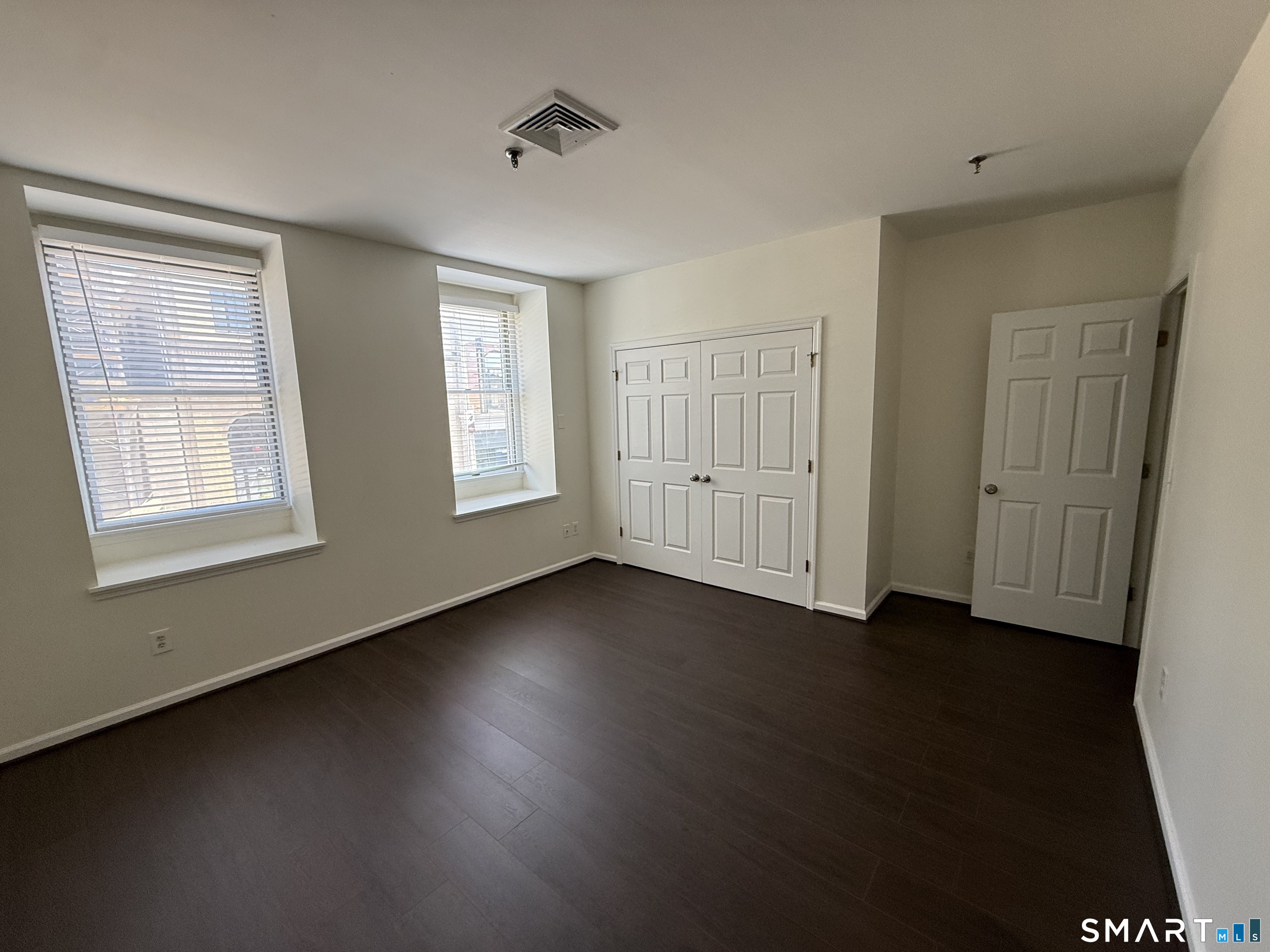 84 Wall Street Norwalk, CT 06850 - Photo 9 of 12 a view of an empty room with wooden floor and a window
