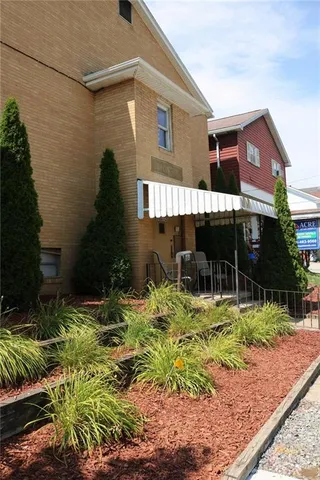 a backyard of a house with a yard and outdoor seating