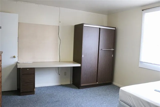 a room with a refrigerator and cabinets