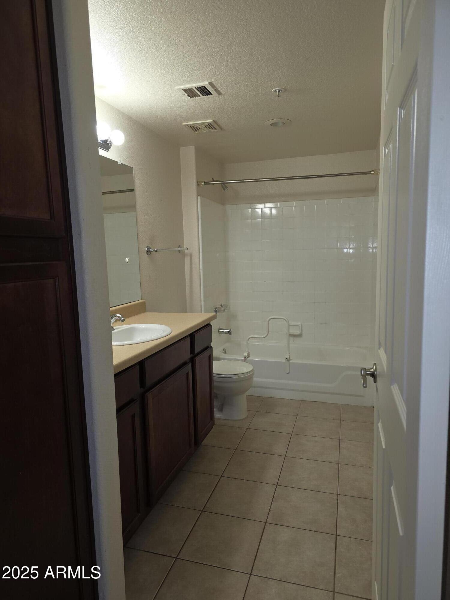 750 East Northern Avenue, Unit 1052 Phoenix, AZ 85020 - Photo 11 of 15 a bathroom with a sink a toilet and shower